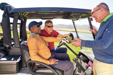 Male Golfers Talking At Sunny Golf Cart