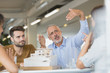 © Tom Merton/Caia Image - Architects discussing model in meeting