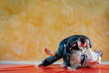 Two Brazilian Jiu Jitsu Athletes Working On BJJ Guard Passing Position At The Training Sparring Or Drilling Fighters At The Academy Class Wearing Kimono Gi