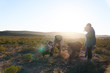 © Trevor Adeline/Caia Image - Safari tour guide explaining plants to group on sunny wildlife reserve
