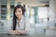 © Martin Barraud/Caia Image - Portrait confident businesswoman at table