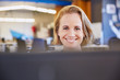 © Ryan Lees/Caia Image - Portrait smiling businesswoman working at computer