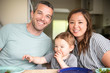 © Jarusha Brown/Caia Image - Portrait happy young family eating