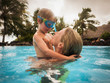 © Paul Bradbury/Caia Image - Mother and son hugging in swimming pool