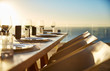 © Chris Ryan/Caia Image - Sunset behind placesettings on luxury patio dining table