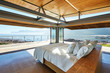 © Chris Ryan/Caia Image - Modern luxury bed open to patio with sunny ocean view