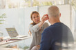 © Tom Merton/Caia Image - Female doctor helping male patient with hearing aid in doctor‚Äôs office