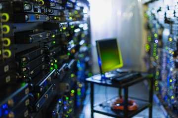 Computer on cart in server room corridor