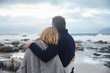 © Ryan Lees/Caia Image - Serene couple hugging on winter beach