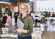 © Ryan Lees/Caia Image - Smiling businesswoman in office