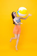 © Atstock Productions - Happy young Asian woman in casual summer clothes playing beach ball