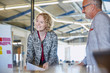 © Ryan Lees/Caia Image - Smiling businesswoman leading meeting in conference room