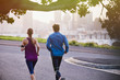 © Ryan Lees/Caia Image - Runner couple running on urban city street