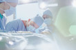 © Tom Merton/Caia Image - Focused male surgeon performing surgery on female patient in operating room