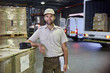 © Ryan Lees/Caia Image - Portrait confident truck driver worker at distribution warehouse loading dock