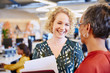 © Ryan Lees/Caia Image - Smiling businesswomen talking in office