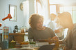 © Justin Pumfrey/Caia Image - Young men college students studying at sunny dining table