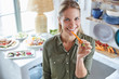 © Ryan Lees/Caia Image - Portrait smiling woman eating carrot