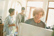 © Justin Pumfrey/Caia Image - Smiling young man opening refrigerator