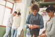 © Justin Pumfrey/Caia Image - Young couple roommates cooking in kitchen