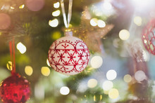 Red And White Ornament Hanging From Christmas Tree