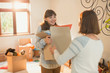 © Justin Pumfrey/Caia Image - Mother helping young adult daughter moving into new apartment