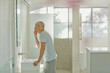 © Tom Merton/Caia Image - Mature man touching face at bathroom mirror