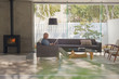 © Tom Merton/Caia Image - Mature man relaxing, using digital tablet on sofa in living room with fireplace