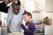 © Sam Edwards/Caia Image - Playful father and son baking in kitchen