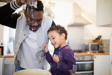 Playful Father And Son Baking In Kitchen