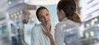 © Tom Merton/Caia Image - Attentive businesswoman listening to colleague in office