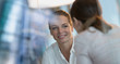 © Tom Merton/Caia Image - Smiling businesswoman listening to colleague