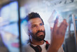 © Tom Merton/Caia Image - Focused, innovative male entrepreneur examining glass triangle prototype