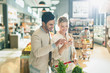 © Tom Merton/Caia Image - Young couple using cell phone, grocery shopping in grocery store market