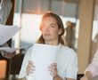 © Tom Merton/Caia Image - Serious, pensive businesswoman with paperwork looking away in office