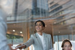 © Tom Merton/Caia Image - Smiling businesswoman handing paperwork to colleague in conference room meeting