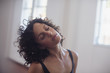 © Sam Edwards/Caia Image - Calm young female dancer stretching neck in dance studio
