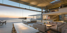 Modern, Luxury Home Showcase Living Room And Dining Room Open To Ocean View At Dusk
