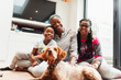 © Paul Bradbury/Caia Image - Portrait happy multi-generation family with dog on living room floor