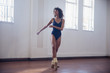 © Sam Edwards/Caia Image - Smiling young female dancer practicing in dance studio