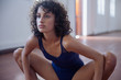 © Sam Edwards/Caia Image - Focused, strong young female dancer stretching in dance studio
