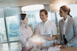© Tom Merton/Caia Image - Businesswomen with digital tablet talking in conference room meeting