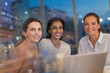 © Tom Merton/Caia Image - Portrait smiling, confident businesswomen working ate at laptop in conference room meeting