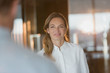 © Tom Merton/Caia Image - Confident businesswoman listening to colleague in office