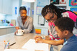 © Paul Bradbury/Caia Image - Grandmother and grandson coloring in kitchen