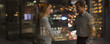 © Tom Merton/Caia Image - Businessman and businesswoman handshaking in office at night