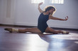 © Sam Edwards/Caia Image - Graceful young female dancer doing the splits in dance studio