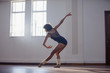 © Sam Edwards/Caia Image - Graceful young female dancer practicing in dance studio