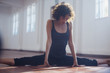 © Sam Edwards/Caia Image - Strong young female dancer stretching, doing the splits in dance studio
