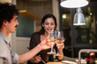 © Sam Edwards/Caia Image - Couple toasting white wine glasses in apartment kitchen